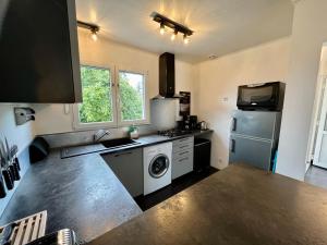 a kitchen with a refrigerator and a washer and dryer at Wine O'Clock in Chablis