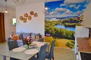 a dining room with a painting of a lake at Noclegi Bero Fejn in Lipusz