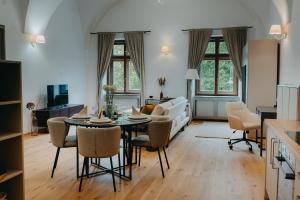 a kitchen and living room with a table and chairs at Contessa Apartments in Košice