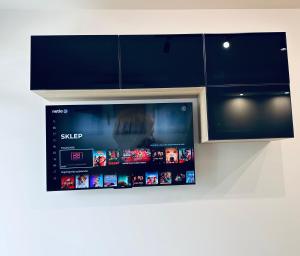 a tablet on the wall of a kitchen at Apartament Modesta Przy Aquaparku Reda in Rumia