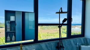 a bathroom with a window with a blow dryer in it at Gành Đá Đĩa Retreat Hotel in Tuy An +113 photos