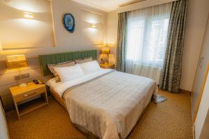 A bed or beds in a room at La Palace Exclusive Design