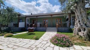a house with a tree in front of it at Villa Alexandra studios in Limenas