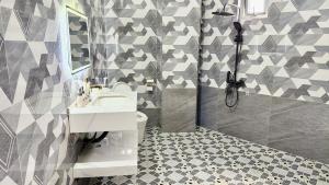 a bathroom with a sink and a toilet at Gành Đá Đĩa Retreat Hotel in Tuy An