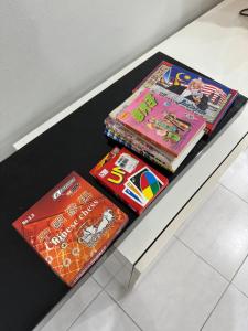 three childrens books sitting on a table at 16 pax HB Homestay Raja Uda Ong Yi How Butterworth - Budget Homestay - KTV NETFLIX MAHJONG in Butterworth