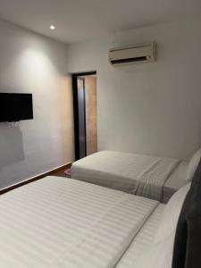Winn's Hotel Bentong客房内的一张或多张床位