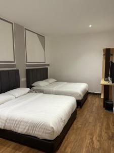 Winn's Hotel Bentong客房内的一张或多张床位