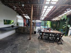 a patio with a table and chairs in a room at Pousada Acayaca in Diamantina