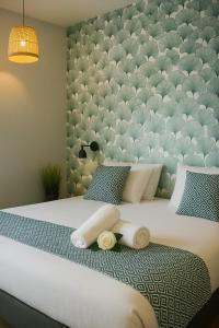 a bedroom with a large bed with a large wall at Hotel & Spa Gil de France Cap d'Agde in Cap d'Agde