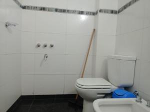 a white bathroom with a toilet and a sink at Virginia hotel in La Quiaca +26 photos