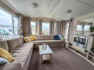 a living room with a couch and a table at Great 6 Berth Caravan In Essex At St Osyth Beach Holiday Park Ref 28018Mv in Clacton-on-Sea