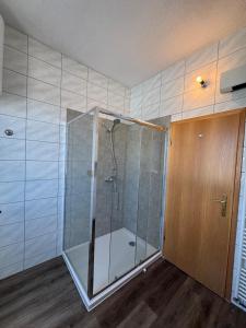 a shower with a glass door in a bathroom at Apartman Mandurić in Posušje