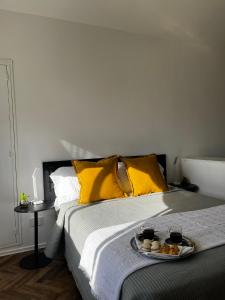 a bed with a tray of food on it at MINISUITE GAONA - Studio - Estacion de Ramos Mejia in Ramos Mejía