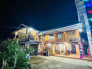 a building with a motorcycle parked in front of it at Homestay Quyền Đen in Mù Cang Chải