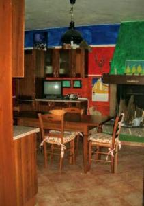 a dining room with a wooden table and chairs at Apartamento Pino Verde in San Colombano VT Vista, Natura, Wifi in San Colombano +26 photos