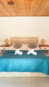 a bedroom with a blue bed with two towels on it at Rida Village Ksamil Island in Ksamil