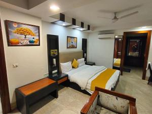 a bedroom with a bed and a bench in it at Stay Inn Residency in New Delhi