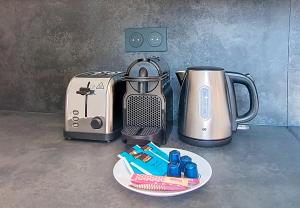 a counter with a coffee maker and a toaster at Appartement central - My Home in Argenteuil