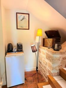 a room with a refrigerator and a tv on the wall at Chambre La Dracysienne in Dracy-le-Fort +37 photos