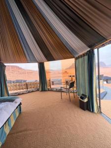 1 dormitorio con cama y vistas al desierto en Rum Awaad luxury camp, en Wadi Rum