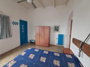 a bedroom with a bed and a wooden door at Casa Lucia in Casamicciola Terme