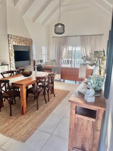 a living room with a wooden table and chairs at 11 on Korhaan Paternoster in Paternoster