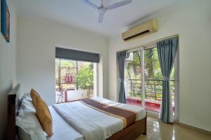 a bedroom with a bed and a large window at Luxury 3BHK Villa With Private Pool in Candolim in Nerul +51 photos