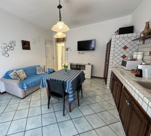 a living room with a table and a couch at AMATI HOLIDAYS in Palermo