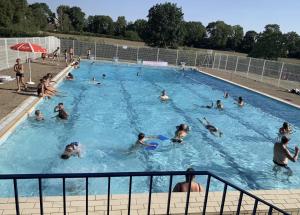 a group of people swimming in a swimming pool at La Belle Epoque in Époisses