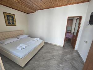 a bedroom with a bed with towels on it at Star Room's in Vlorë