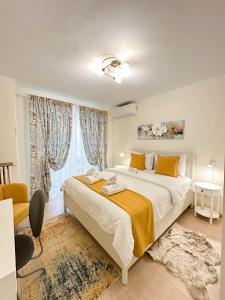 a bedroom with a large bed and a window at Sunrise Apartments City Center in Bucharest