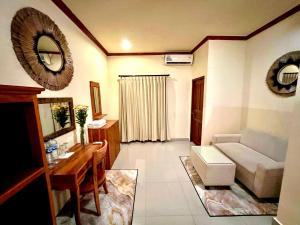 a living room with a couch and a table at Guesthouse Gusti Putu Oka in Ubud