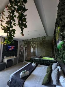 a bedroom with a large bed with plants on the wall at La collina di Capodimonte in Naples