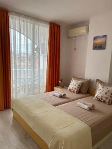 A bed or beds in a room at Guest House Pomorie