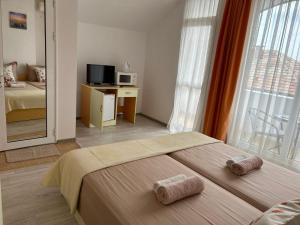 A bed or beds in a room at Guest House Pomorie