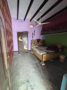 a bedroom with two beds and purple walls at Urmila homestay in Chhāensa