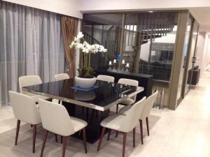 a dining room with a black table and white chairs at By the Sea PENTHOUSE duplex in Batu Ferringhi +17 photos