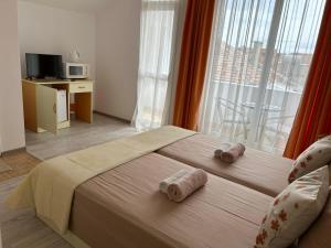 A bed or beds in a room at Guest House Pomorie