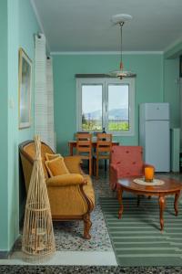 a living room with a couch and a table at Orange Blossom Apartment in Nafplio