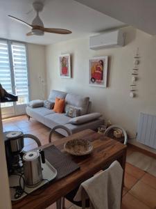 a living room with a couch and a table at Appartement Syrah in Collioure +10 photos