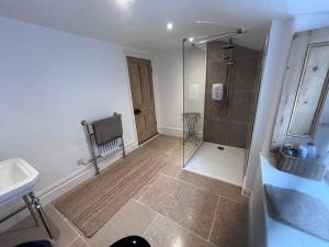 a bathroom with a shower and a sink at The Old School House in Bristol