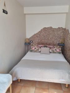 a bedroom with a bed with a laptop on it at Appartement Syrah in Collioure
