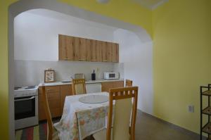 a kitchen with a table and two chairs and a stove at Virgin spring in Kumbor