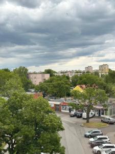 a city with cars parked in a parking lot at MIA Apartman in Nyíregyháza