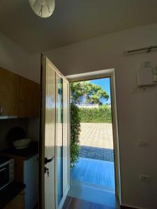 an open door to a patio with a view at "Seaside Pines" Apartments in Vlorë