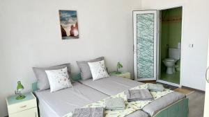 A bed or beds in a room at Guest House Pomorie