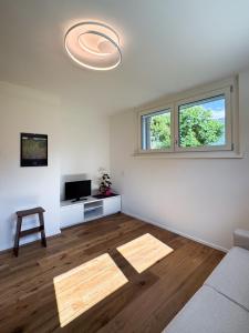 an empty living room with a couch and a window at Enrichetta Apartment in Castione Andevenno
