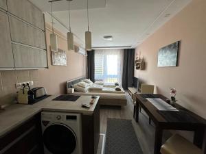 a living room with a bed in the background at MIA Apartman in Nyíregyháza