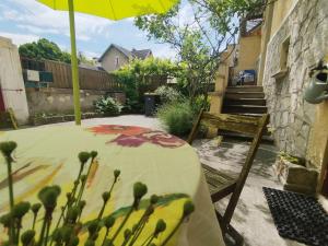 a table with an umbrella on a patio at Studio Athena in Aix-les-Bains