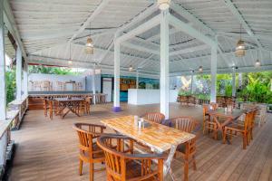 a dining room with wooden tables and chairs at The Kleep Jungle Resort in Nusa Penida